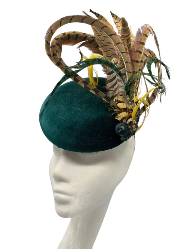 Stunning green velvet headpiece with feather detail.